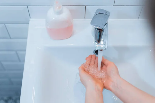 Woman wash his hands with soap to privent infection from coronavirus (COVID-19)