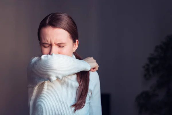Öksürürken burnu ve ağzı kaplayan dokuda öksürük. Avrupalı kadın evde grip olmuş..