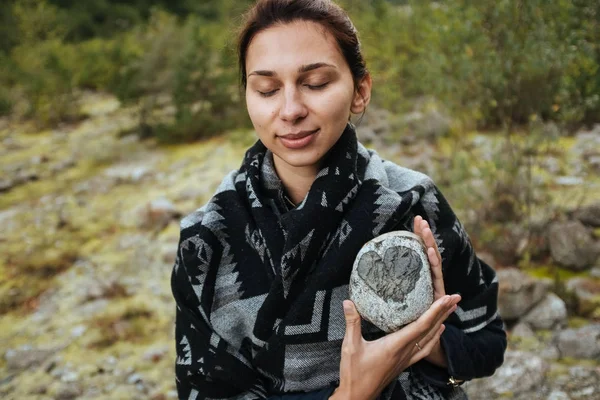 Bir taş onun elinde tutan genç bir kadın
