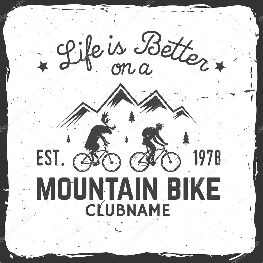 Vintage typography design with car and trailer, mountain bikes and mountain silhouette.