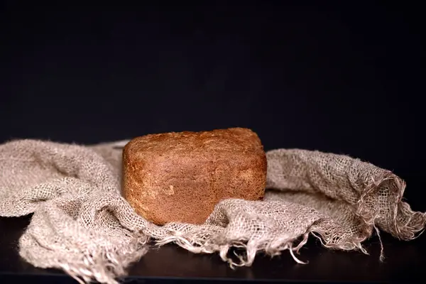 Freshly baked bread is fragrant on linen tablecloths. Stock Image