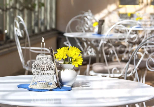 Morning in a cafe that has just opened. The chairs are empty. The morning sun shines into the room.