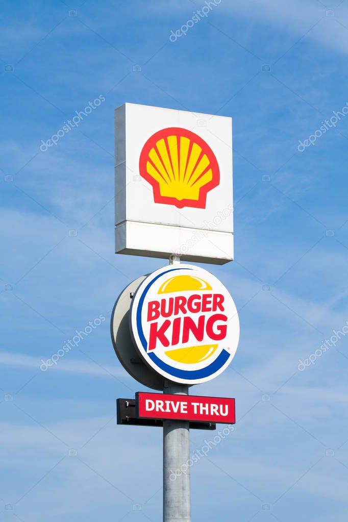 Warsaw, Poland - July 08, 2017: Shell and Burger King pylon on blue sky background near the highway.