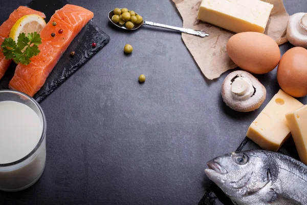 Black slate table with product rich in omega 3 and vitamin D. — Stock Photo, Image