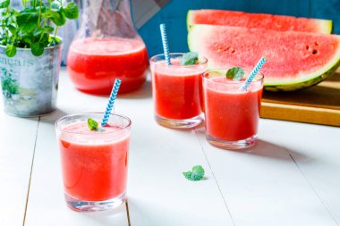 Taze karpuz smoothies, gözlük tahta masada duruyor.