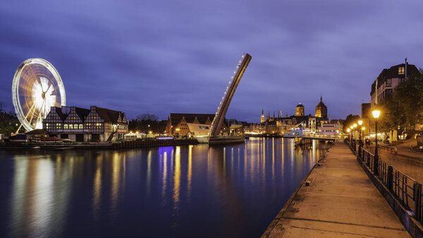 Amazing lights on cityscape of evening Gdansk, view from Wapienny Bridge on bascule footbridge.