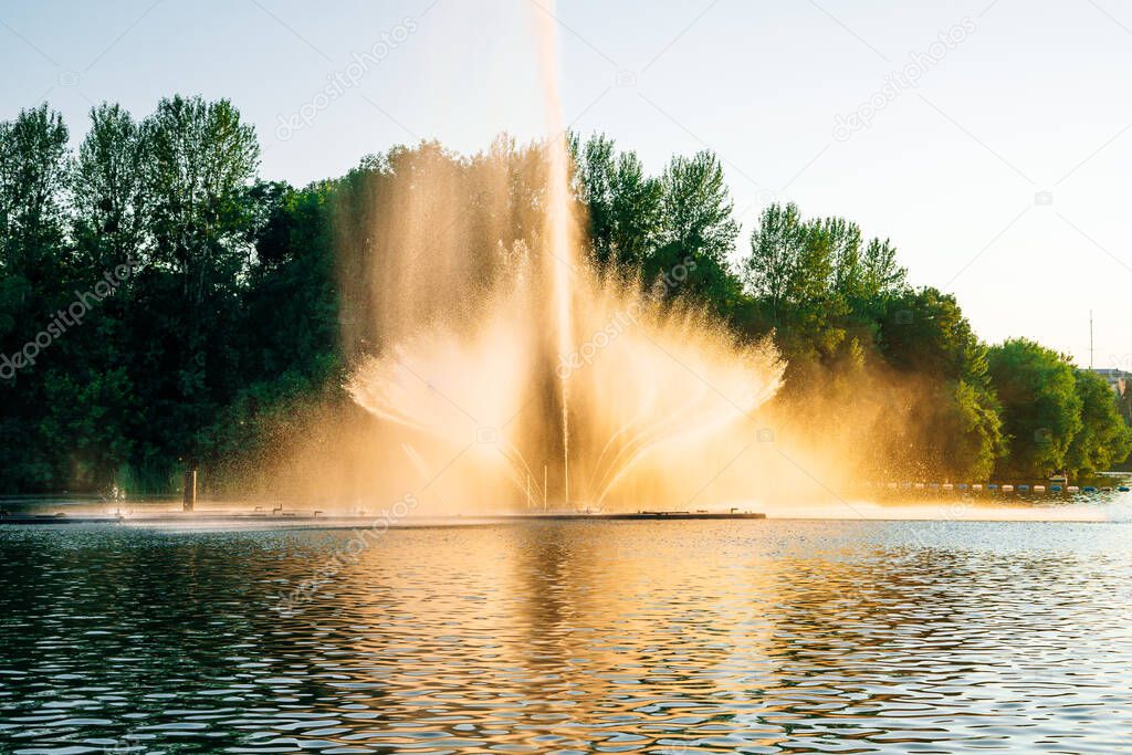 Vinnitsa, Ukraine. Dancing fountain on the river. Beautiful fountain on sunset background.