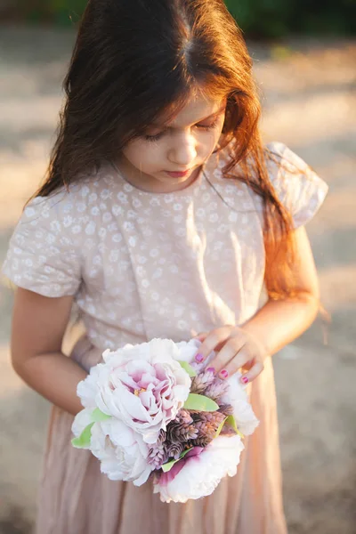 Little girl with wedding bouquet Stock Photo