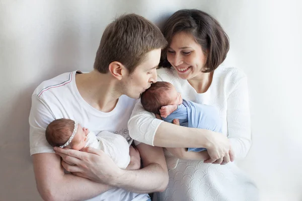 Parents holding newborn girl  and boy — Stock Photo, Image
