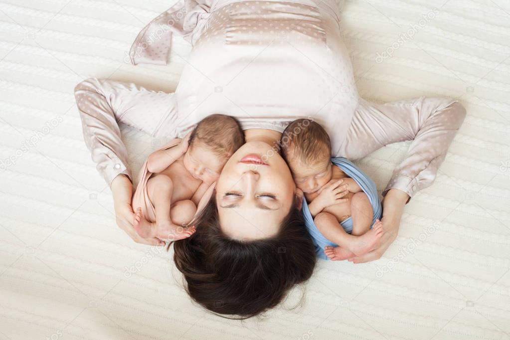 mother lying with  newborn girl  and boy