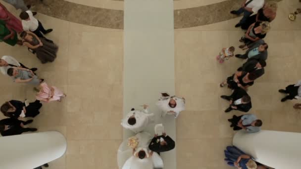 Look from above at wedding procession walking into the church. — Stock Video