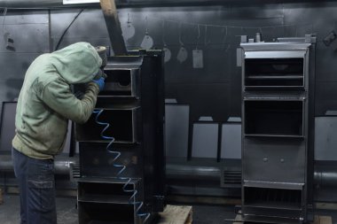 Katı yakıtlı kazan bitki üzerinde çalışan takım elbiseli adam boyalar