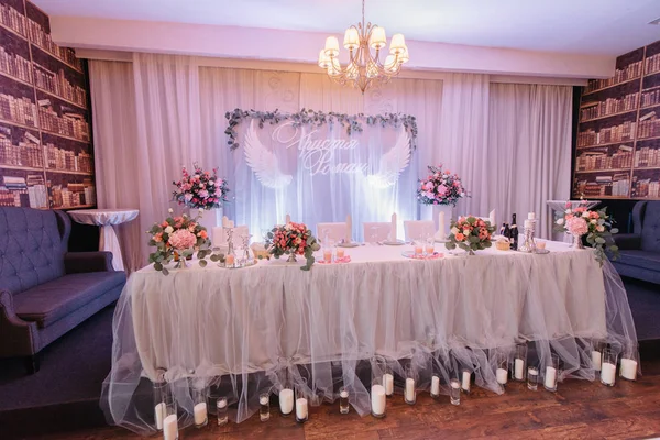 Long dinner table covered with veil stands in cosy restaurant — Stock Photo, Image