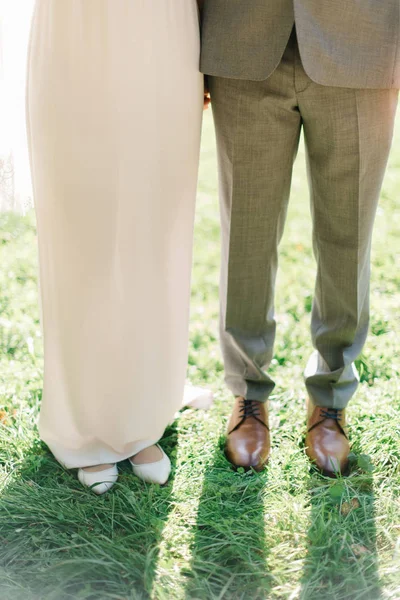 Sposo e sposa in abito semplice stand su erba verde — Foto Stock