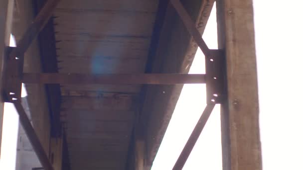 Sunlight through the ruins of an old factory,iron constructions, anamorphic lense — Stock Video