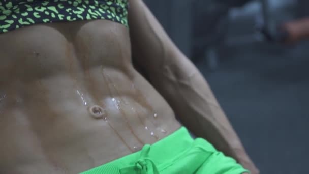 Young beautiful woman shows press on the stomach workout training results — Stock Video