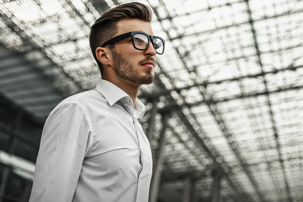 Detail pohledný podnikatel v bílé košili a brýle kontrola času na ulici při čekání na někoho, kdo na kancelářské budovy pozadí. — Stock fotografie