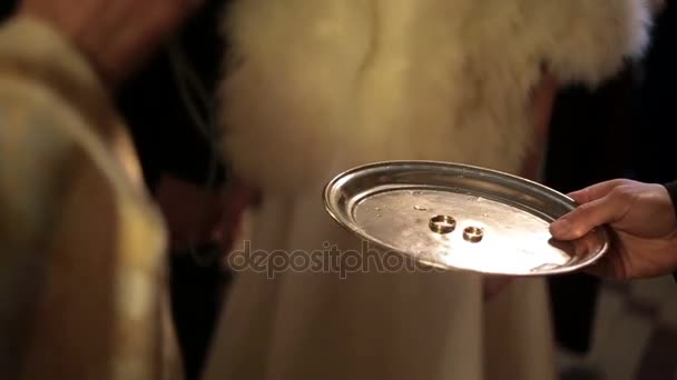 司祭は聖なる水で結婚指輪を祝福します。 — ストック動画