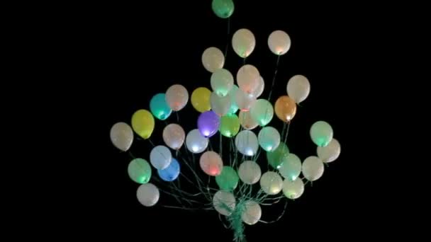 Balões coloridos erguem-se no céu noturno — Vídeo de Stock