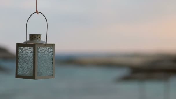 Lonely lantern swings on the wind with sea on background — Stock Video