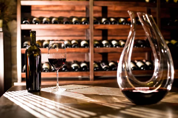 WIne vault place. Wine bottles and wine glass placed on the table and shelves. — Stock Photo, Image