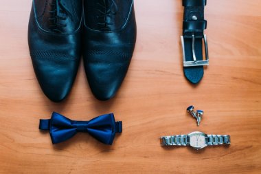 Siyah adam ayakkabı, siyah kemer, handwatch, kol düğmeleri ve mavi kelebek kompozisyon