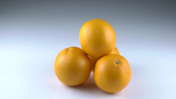 Close-up view of the four oranges taken by different hands of people. — Stock Video