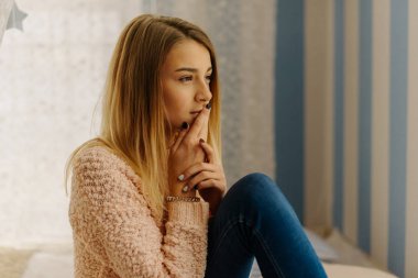 Pencereden bakarak throughtful genç yan portresi.