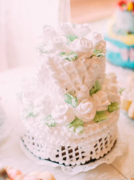 The wedding cake decorated with white freshcream and flowers.