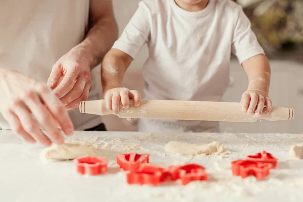 Close up shot of adult and childs hands making a dough for baking cookies. — Stock Photo, Image