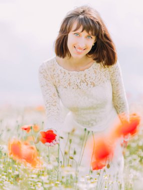 Yakın çekim alanında haşhaş dokunmadan gülümseyen gelin portresi.