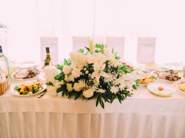 Büyük beyaz buket düğün tablo gıda ile yerleştirilen.