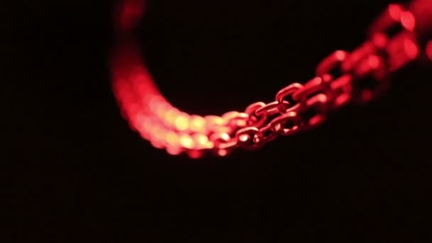 Chain lit with red light — Stock Video