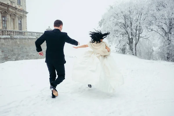 Full-length Groom Following Beautiful Bride Running Away Winter Forest Horizontal Back View Wedding Newlywed Couple. — Stock Photo, Image