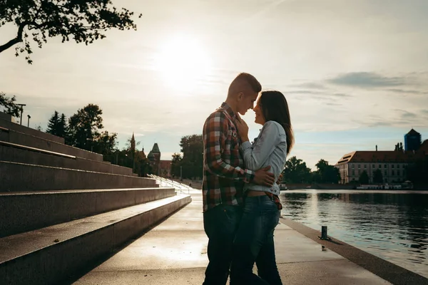 Романтичний портрет усміхненої красивої пари, що обіймається під час заходу сонця . — стокове фото