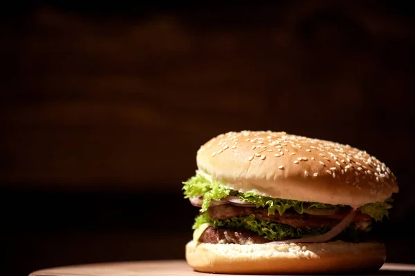 Zbliżenie duże, smaczne mięso burger umieszczone na płycie. — Zdjęcie stockowe