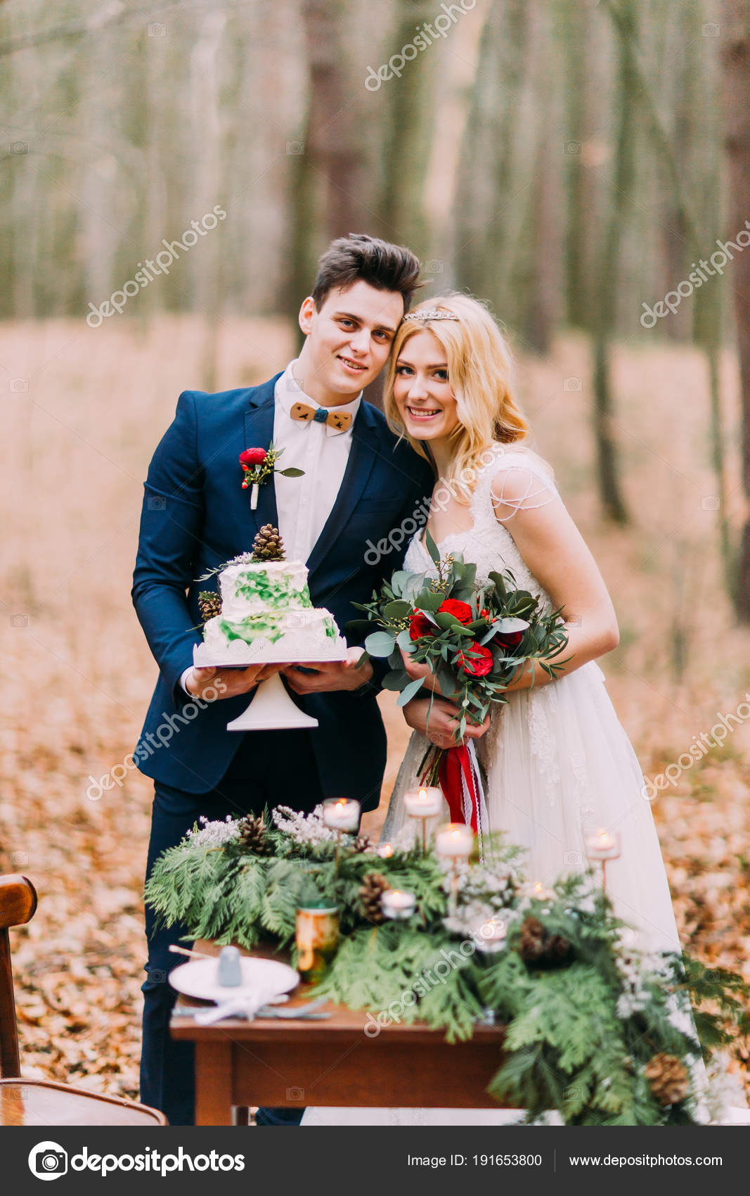 Beautiful Wedding Couple Posing With Cake In Hands Near The