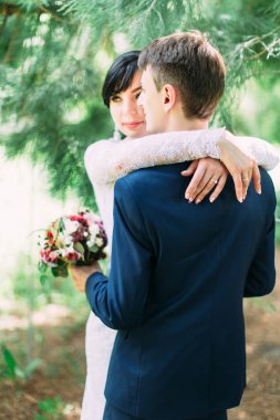 Ormandaki sarılma yeni evliler. Damadın arkadan görünüm.