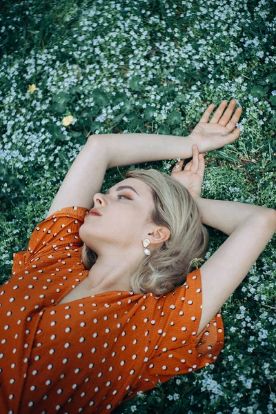 Hermosa mujer acostada disfrutando del campo de margaritas, chica bonita relajándose al aire libre. Primer plano — Foto de Stock