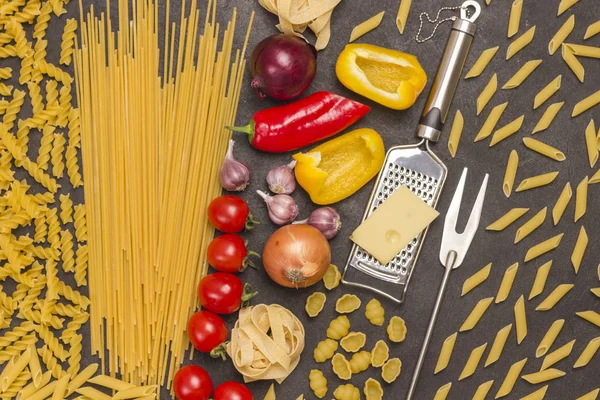 Organic food  on black background. Variety of types and shapes pasta