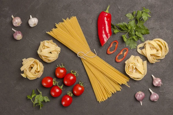 Organic food  on black background. Variety of types and shapes of Italian pasta