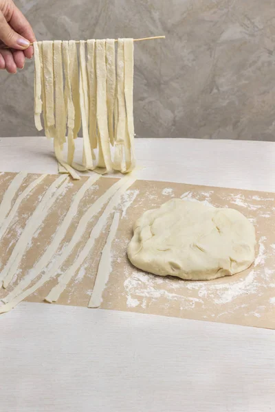 Rolled dough, sliced into strips. Process of making homemade pasta — 스톡 사진