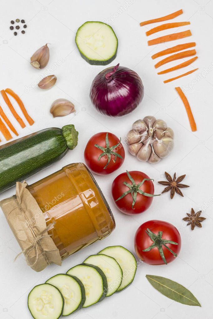 Fermented squash spread in glass jar. Raw vegetables and spices: carrots garlic, onions tomatoes, star anise, chili peppercorn. Healthy winter nutrition. Fermentation Products. White background. Flat lay