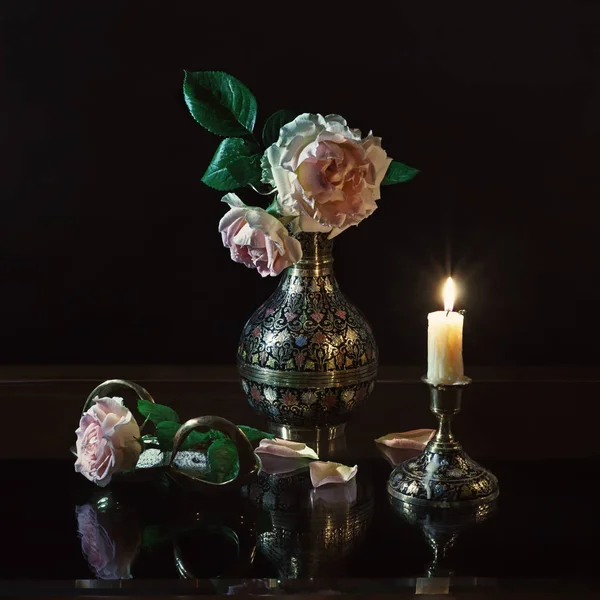 Still life of roses in candle light
