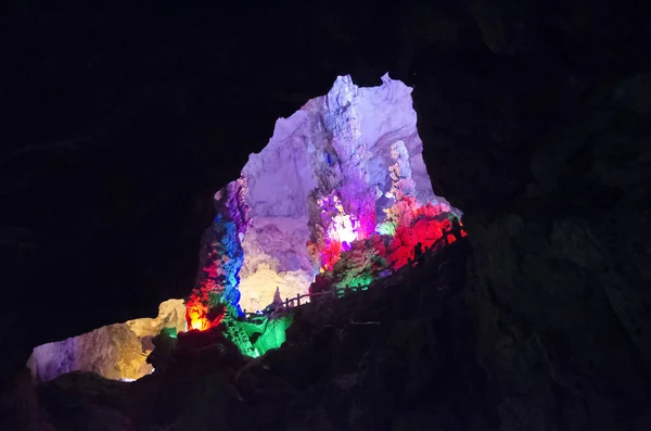 Beautiful illuminated multicolored stalactites from karst Reed Flute cave. Guilin Guangxi China — Stock Photo, Image