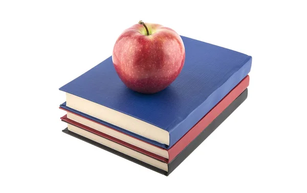 Libros con manzanas sobre fondo blanco — Foto de Stock