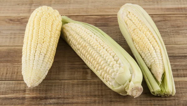 Cob of corn on a wooden background — Stock Photo, Image