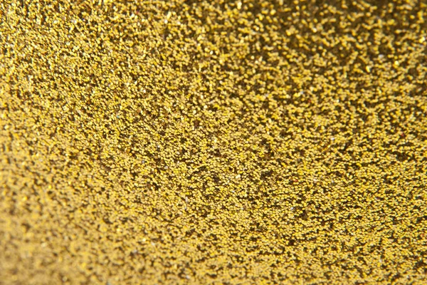 Textura de um fundo dourado brilhante de decorações festivas — Fotografia de Stock