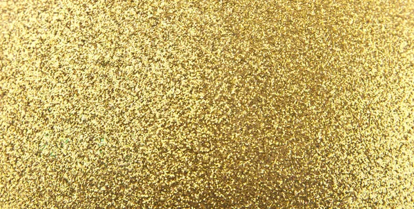 Textura de um fundo dourado brilhante de decorações festivas — Fotografia de Stock