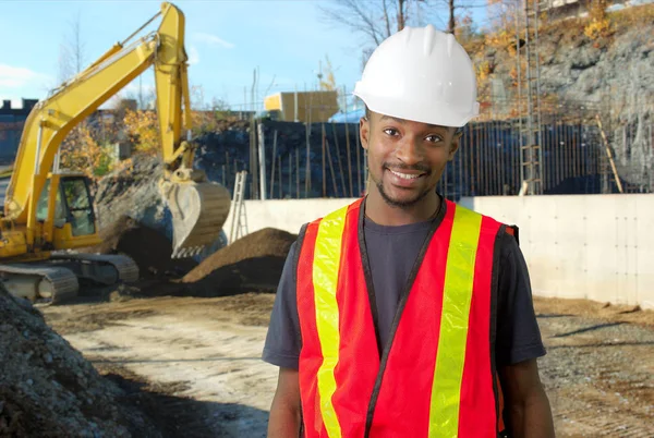 Construction site worker orange jacket and white security helmet — Stock Photo, Image